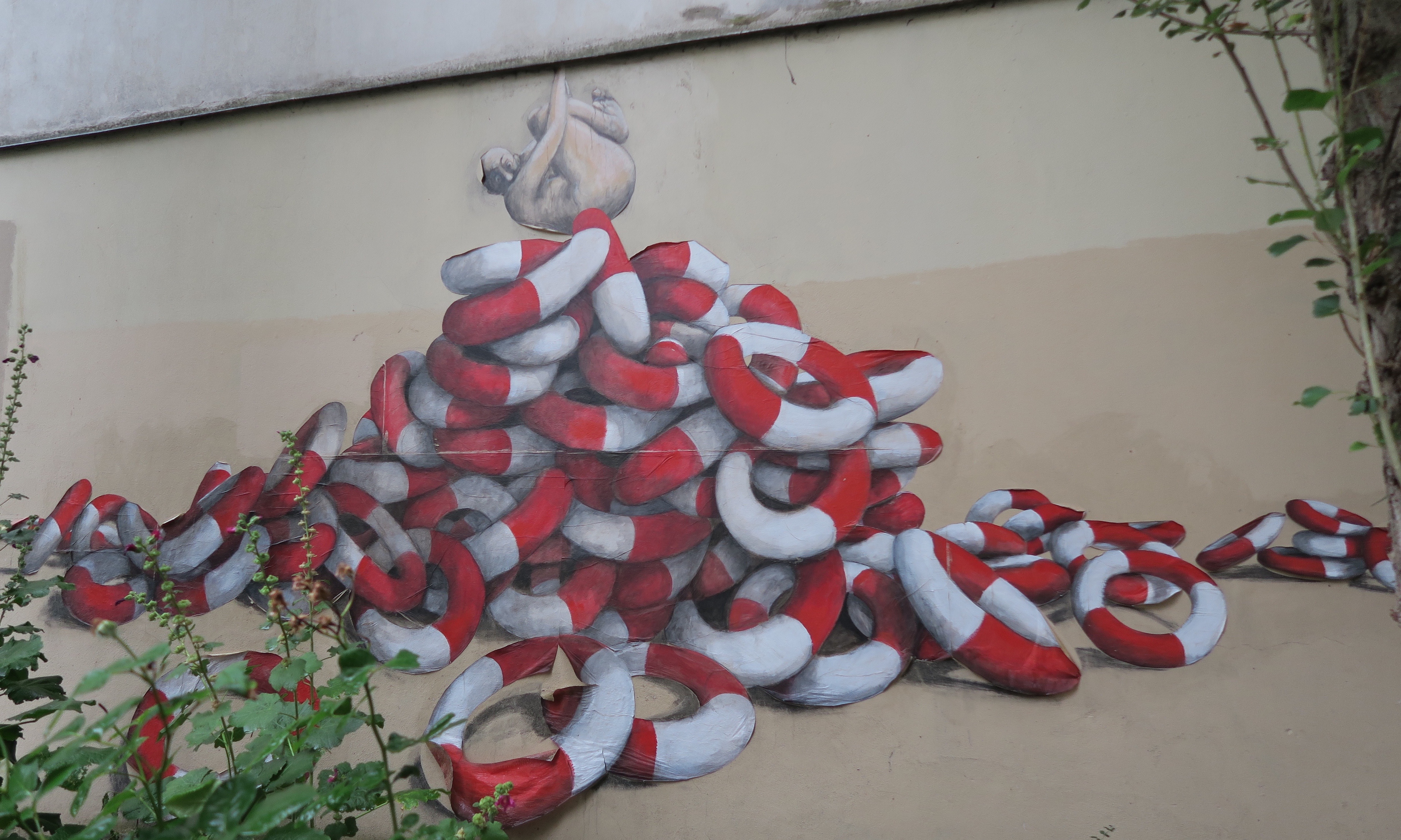 Street art by Philippe Girard with his signature life saver rings, Belleville