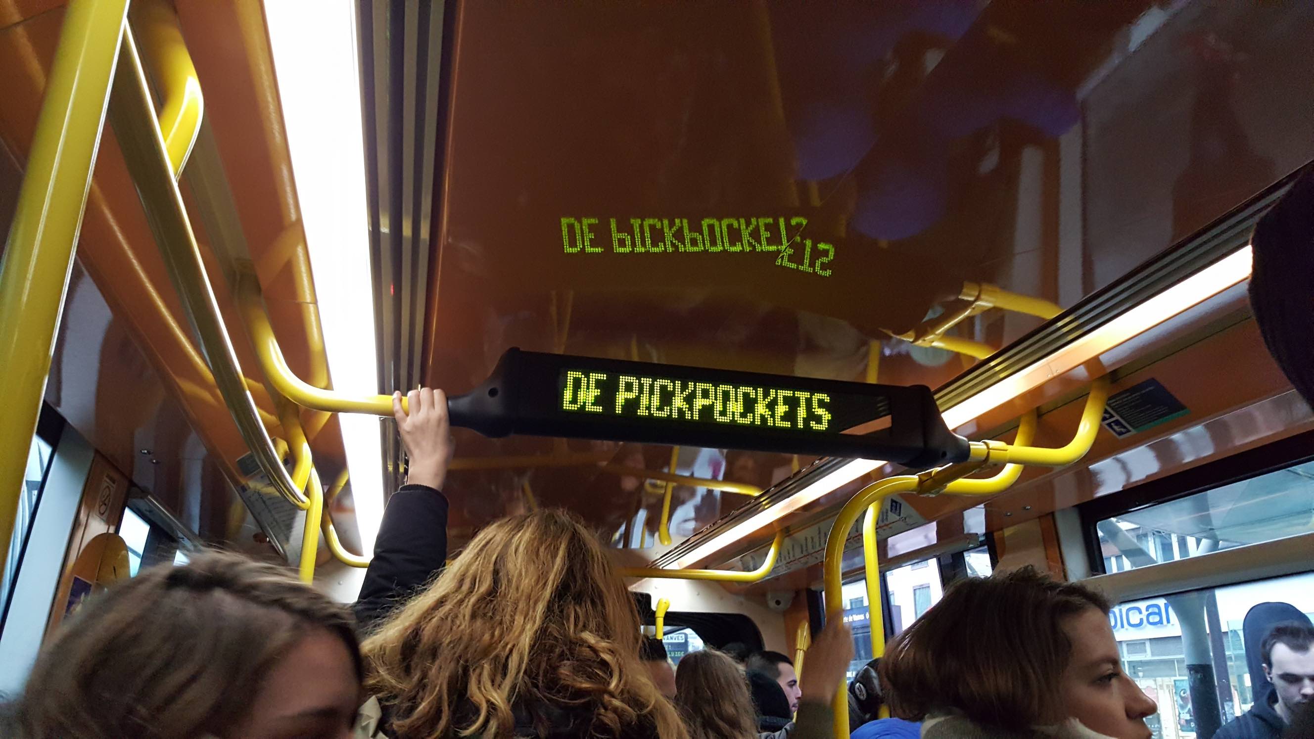 An overhead sign on a Paris tram warns passengers about pickpockets.